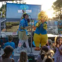 Spectacle pour enfants au camping avec mascotte jaune.